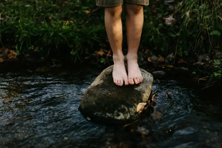 standing on a natural rock earthing grounding 